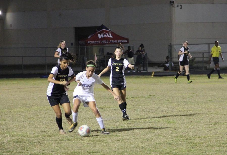 Communications senior Danielle Cuestas steals the ball from a Forest Hill Community High School player in an attempt to defend Dreyfoos’ goal and get the ball to the other side of the field.