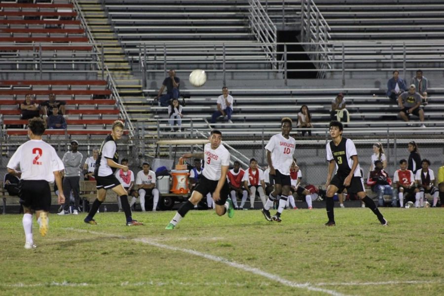 Visual junior Gabriel Veliz and band junior Ryan Svopa prepare to go after the ball as they attempt to block players from Santaluces Community High Schools’ soccer team at their game on Dec. 6. 