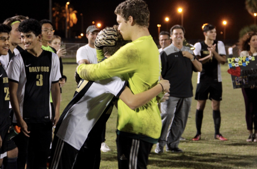 Communications senior Skyler Buitrago embraces his younger brother, band freshman Nico Buitrago, after Nico delivered a tear-jerking speech thanking his brother for their most memorable times together growing up. As Skyler and other seniors on the team prepare to graduate, a special ceremony was held at their final regular season game, where families and fellow players honored the seniors. “Playing with Nico was great,” Skyler said. “We’re at the age gap where I wasn’t in middle school with him so I only get this one year in school with him before I head out. I’m going to keep working with him and pushing him because he’s an amazing athlete, and he will see that very soon. I’m so glad that my for my last year at Dreyfoos I was able to spend the season with him by my side.”