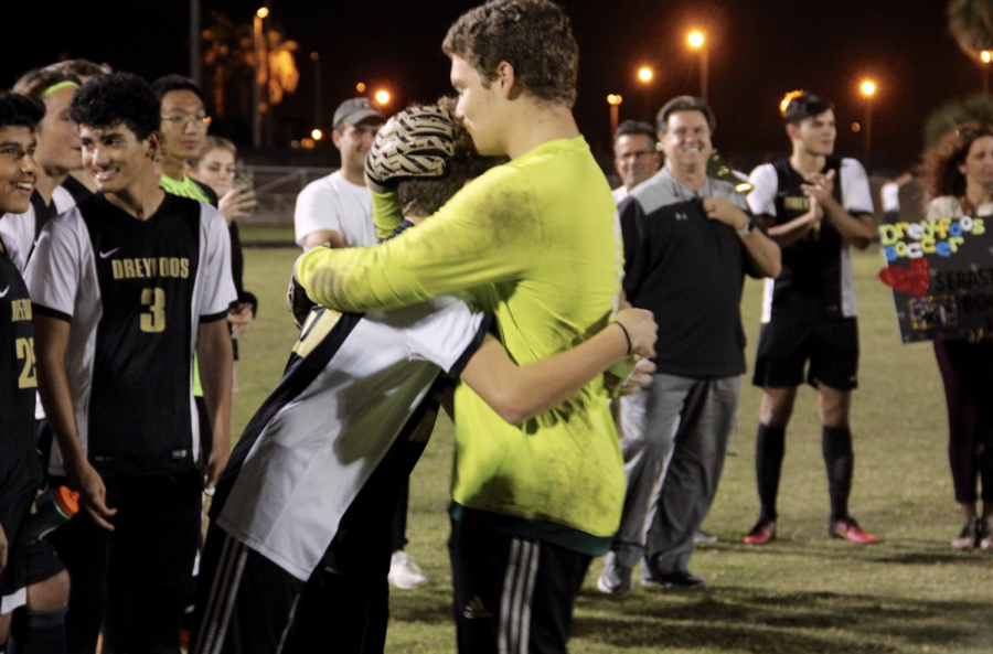 Communications+senior+Skyler+Buitrago+embraces+his+younger+brother%2C+band+freshman+Nico+Buitrago%2C+after+Nico+delivered+a+tear-jerking+speech+thanking+his+brother+for+their+most+memorable+times+together+growing+up.+As+Skyler+and+other+seniors+on+the+team+prepare+to+graduate%2C+a+special+ceremony+was+held+at+their+final+regular+season+game%2C+where+families+and+fellow+players+honored+the+seniors.+%E2%80%9CPlaying+with+Nico+was+great%2C%E2%80%9D+Skyler+said.+%E2%80%9CWe%E2%80%99re+at+the+age+gap+where+I+wasn%E2%80%99t+in+middle+school+with+him+so+I+only+get+this+one+year+in+school+with+him+before+I+head+out.+I%E2%80%99m+going+to+keep+working+with+him+and+pushing+him+because+he%E2%80%99s+an+amazing+athlete%2C+and+he+will+see+that+very+soon.+I%E2%80%99m+so+glad+that+my+for+my+last+year+at+Dreyfoos+I+was+able+to+spend+the+season+with+him+by+my+side.%E2%80%9D