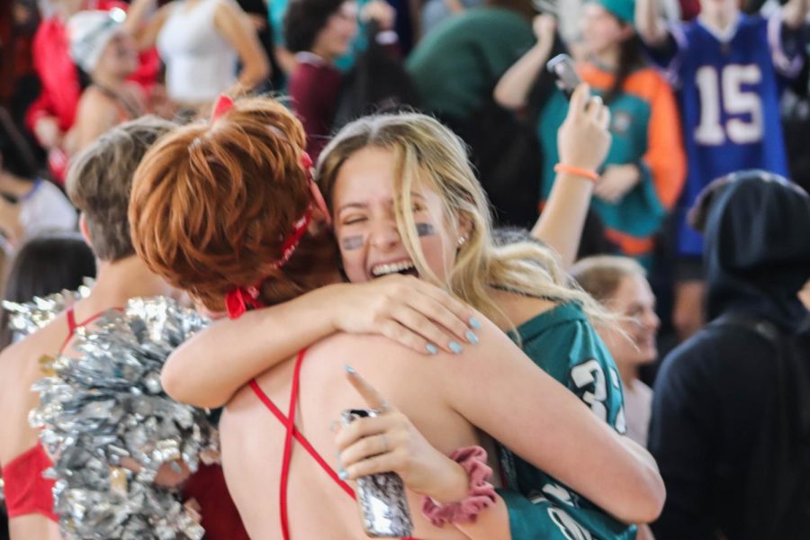 Theatre juniors Mason Taylor, a participating cheerleader, and Danielle Goldfine embrace each other in joy after SGA announced the winners of the 2018 Powderpuff cheerleading match, with juniors in first place.