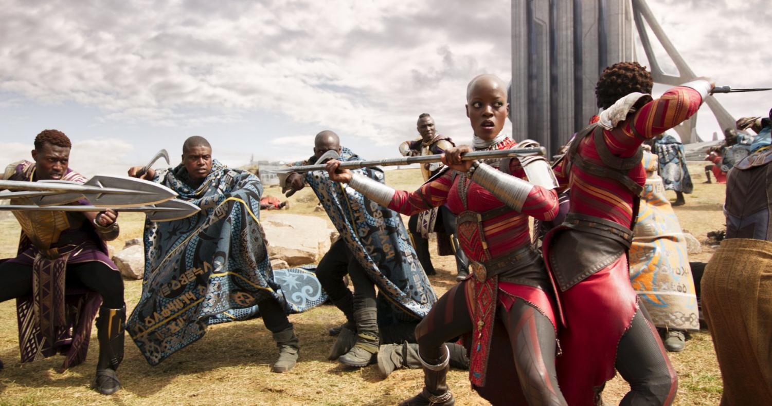 The Warriors of Wakanda stand tall in a fierce battle to defend their nation. As they wield modern weapons of war, they are dressed in garb true to their culture.