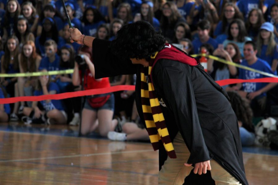 Mr. Mora triumphantly raises his wand as he fights off the death eaters in the seniors Pep Rally skit. The skit was directed by theatre senior Ethan Izenwasser, who took inspiration from the Harry Potter fight scenes to direct it.