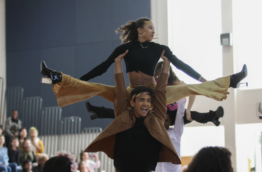 Theatre junior Jaden Martinez lifts dance junior Tatiana Nuñez into the air as the two participate in the juniors’ 70s themed dance alongside their peers. The dance was choreographed by dance junior Gabriella Angel and came in second place amongst the judges, following the seniors who came in first. 
