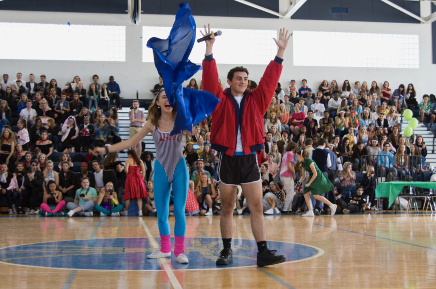 Vocal senior James Ulaszek rips off a pair of fluorescent, button-up pants to reveal running shorts underneath as part of an iconic 80s look while theatre senior Madison Burmeister laughs behind him. The two Student Government Association presidents served as announcers for the Generation Day festivities and narrated the activities to entertain the audience of students. 