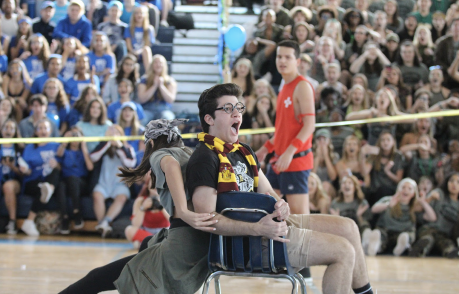 Clad in a Gryffindor scarf, theatre senior Devin Butera forces dance sophomore Dominique Toresco out of the last seat in musical chairs. His victory awarded four points to his class in the first game of the pep rally. Click the link in our bio to read more!
