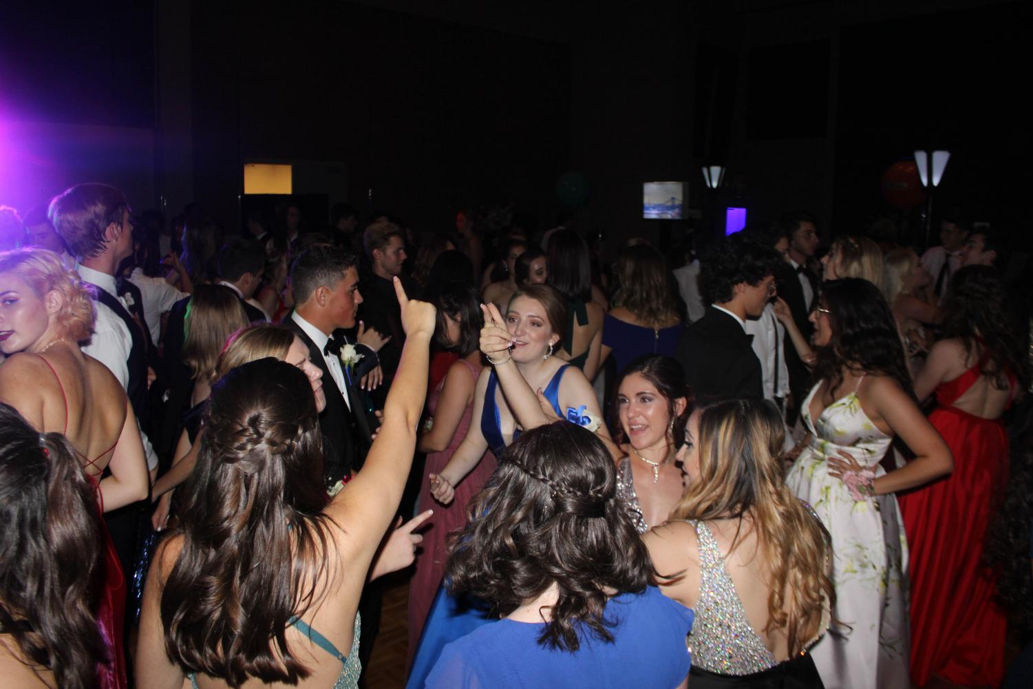 Strings senior Megan Conrad, communications senior Teah Bejarano, and theatre senior Madison Wood all crowd together to sing and dance to the music played by the DJ. As more popular songs began to play, students got up from their seats and headed to the dance floor, which began to fill up quickly as the night persisted.