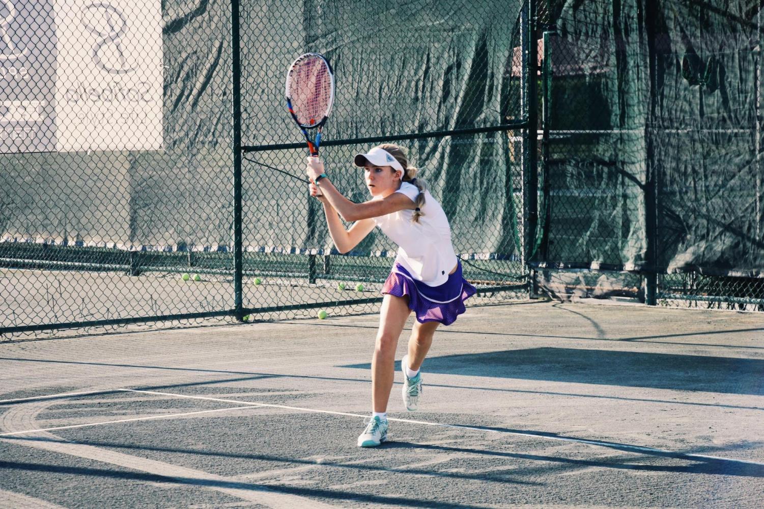 Communications senior Brianna Seaberg follows through with her tennis racket after returning the ball to her opponent. This year marks the fourth year that Seaberg has played for the Dreyfoos tennis team and the first that she has been co-captain. Along with her many other interests, especially film, tennis is a special part of Seaberg’s life that she values as one of her favorite activities. “My favorite part about tennis is that you have to solely rely on yourself,” Seaberg said. “Since tennis is an individual sport, you can have control over every aspect of your own game.”