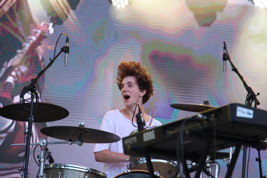 Drummer Walker MacMillan enjoys his time on stage, enthusiastically playing at his drum kit. “What made me want to be in a band was the need to share and experience the feeling of music with other people, not just myself,” MacMillan said. “This not only provides me with different musical perspectives, but helps bring together concepts I couldnt produce on my own.” Student band, Nite Box, received the opportunity to share their music through performing at SunFest.
