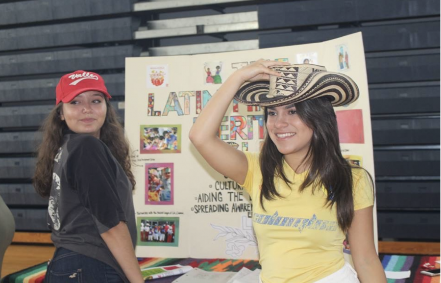 Communications junior and Latin Hispanic Heritage Club President Catalina Correa stands with vocal junior Diana Parra at their table during the 2017 Club Rush. The aim of the club is to provide space for those with Hispanic or Latin heritage to meet and share their experiences. “It allows people to see that Dreyfoos actually is a diverse place,” Correa said. “It also lets Latino students know that theyre not alone.” 

