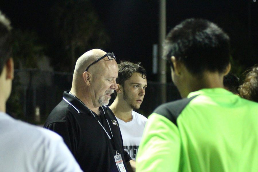 Co-captain and communications senior Louis Dirienzo stands beside foreign language teacher and Dreyfoos boys’ soccer coach Thomas Ruth as he instructs the team for the second half of the game. After losing 3-1 to Palm Beach Lakes High School on Nov. 12 in their first game of the season, he still maintains hope for the long season ahead. “I am very proud of my guys’ effort. [It was] a great game and goal,” Mr. Ruth said. “I really didn’t know what to expect, and I saw that we have a lot of talent and it will get better.”
