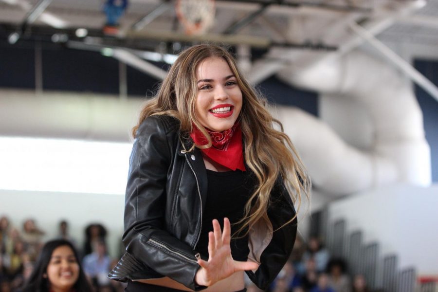 Wearing a leather jacket and bandana, dance freshman Sophia Chambers smiles at the audience. The freshmen placed fourth for their 50’s Generation Day dance.