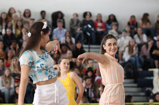 Dance sophomore Morgan Jourdin points to another dancer in the sophomore routine as they kick to beachy ’60s music. The sophomores ended up in third place for the dance, placing behind the juniors and seniors who tied for first.