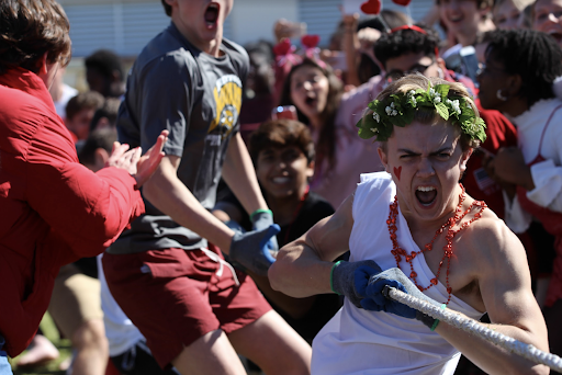 Dressed in a toga with a red heart drawn on his cheek for the Valentine’s Day theme, communications junior Tommy McCabe shouts while pulling the tug-of-war rope. Cheered on by classmates on the sidelines, the junior class won.