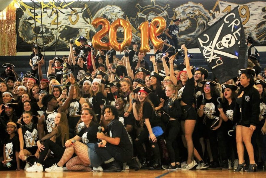 Holding aloft the spirit stick and a pirate flag, the seniors celebrate their pep rally win with a class photo. After the picture, the seniors left the gym and the juniors symbolically took the Class of 2019’s place in the bleachers.