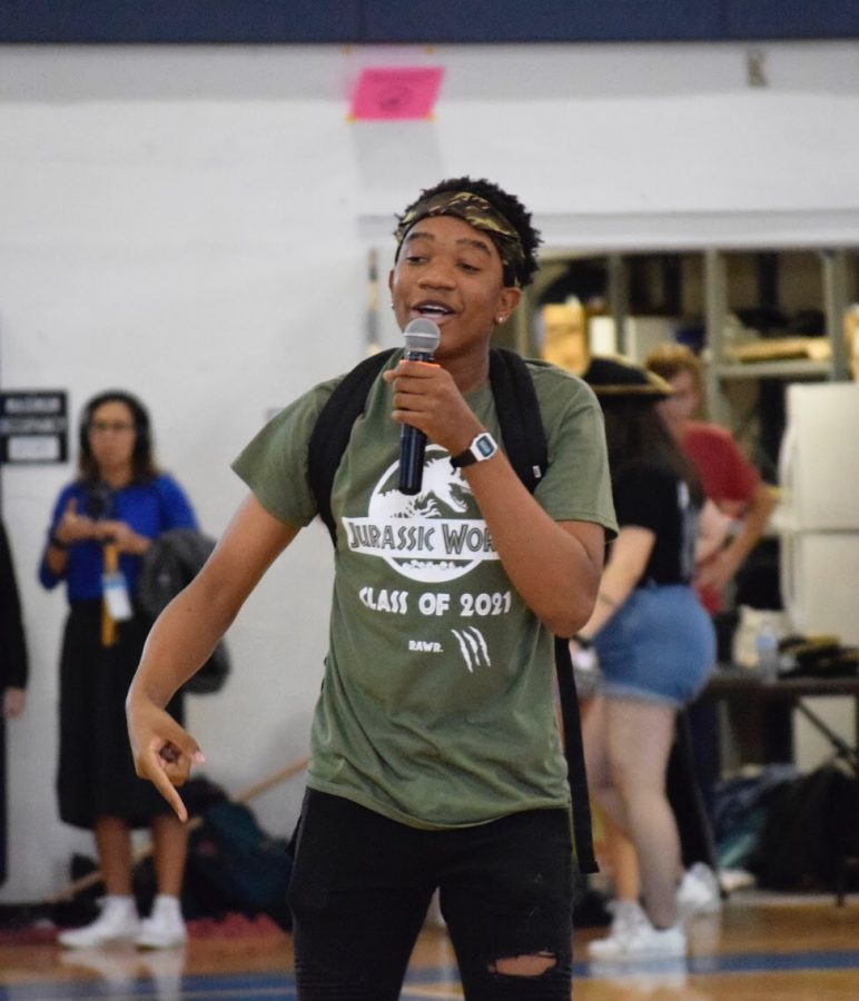 Theatre sophomore Christopher Tuck performs an original rap for the karaoke contest, which also featured some inflatable dinosaur costumes. 