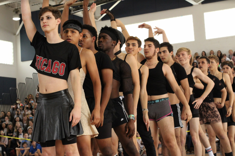 Band senior Grant Conley flicks his wrist in the air as the senior Powderpuff boys line up and perform the choreography created by theatre senior Keiona Nesbitt.