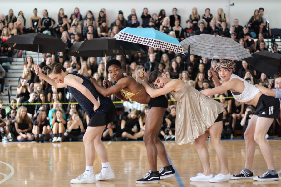 Dance sophomore Carson Van Popering leads the line of Powderpuff boys as they dance with their colorful umbrellas and make the crowds scream with their entertaining dance moves. While the fun props were only used during a portion of the dance, the bleachers full of students never seemed to quiet down. 