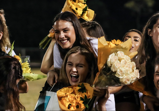 After being presented with flowers, gifts, and reflective speeches for Senior Night from Coach Sarah Garcia and the rest of the girls’ soccer team, a group of seniors gathered in the field at Forest Hill Community High School for a photo. Visual senior Alison MacCloud and vocal senior Danielle Gellen embraced each other with hugs and laughs as they prepared to compete in one of their last games of the season and their high school careers. The girls went on to compete in a district playoff game against Seminole Ridge High School.