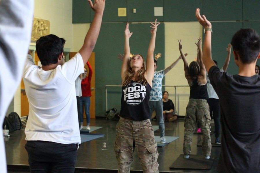 Visual senior Paige Duffack leads students in yoga as they learn ways to live life with a healthy mentality and physicality.