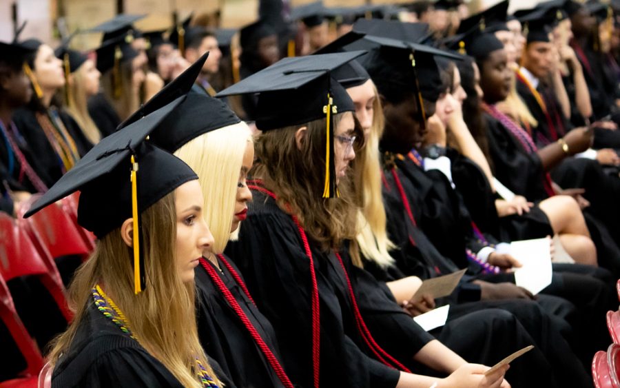 Visual senior Paige Duffack sits with senior classmates near the center of the auditorium while speeches by the salutatorian and valedictorian of Dreyfoos are being delivered. “To the class of 2019: Thank you for being the most skilled, spirited, creative, determined, and strong-willed people I have ever known,” Class of 2019 valedictorian and strings senior Sophia Zheng said. “Im so glad I’m at Dreyfoos School of the Arts, a home that has nurtured us into the thinkers, problem solvers, analyzers, and artists that we are today.”