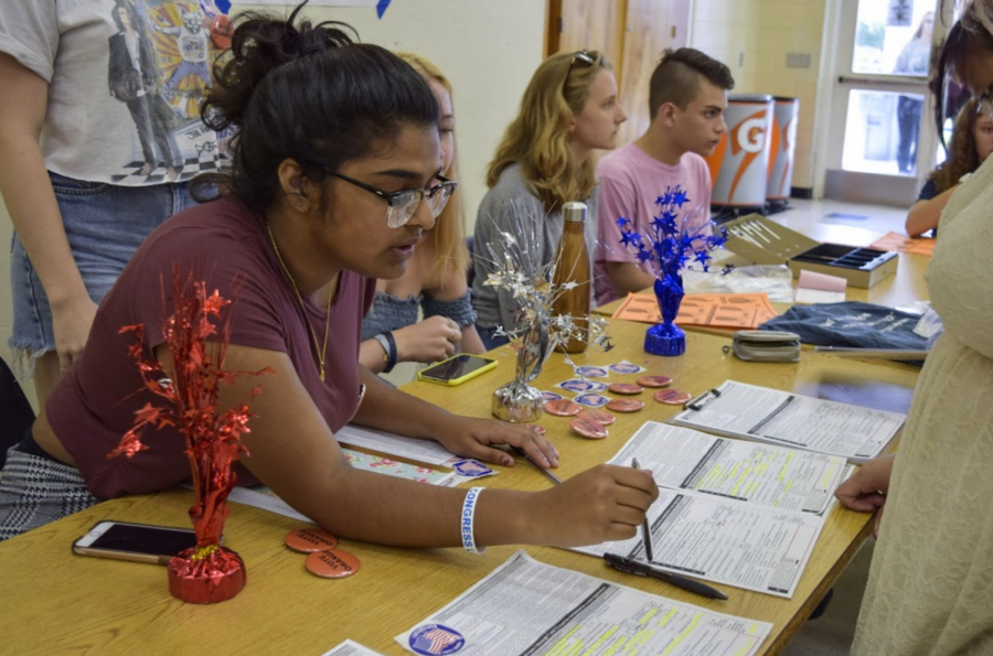 Communications senior Kavyasree Chigurupati instructs a student registering to vote on Oct. 5 as part of a week-long initiative by Students Against Gun Violence to advocate for gun reform.  
