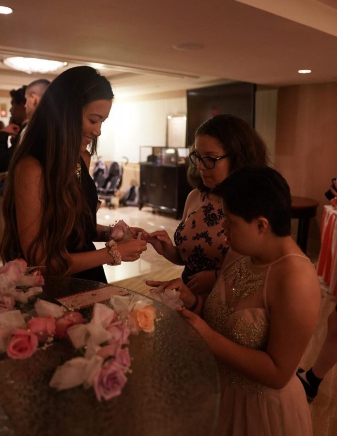 Two+prom+attendees+carefully+pick+out+a+corsage+to+match+their+bejeweled+gowns+before+they+walked+the+red+carpet.+%E2%80%9CI+met+and+talked+to+so+many+patients%2C%E2%80%9D+communications+junior+Sasha+Monaco+said.+%E2%80%9CThey+inspired+me+so+much+with+their+resilience+and+their+positive+attitudes.%E2%80%9D%0A