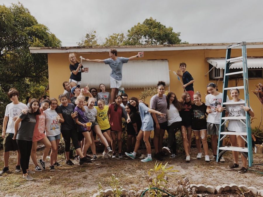 Standing in front of the house they had just painted, sophomores finish Paint Your Heart Out. The photo was posted on the Class of 2022 Instagram page.