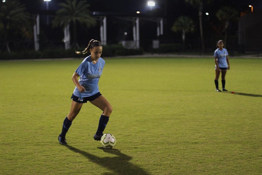 Vocal sophomore Kira Winston plays up on the ball at practice. “Practice goes into everything we do,” Winston said. “In order to be ready for [the showcase in] Texas, we need to practice as much as we can.” (Anna Jones)