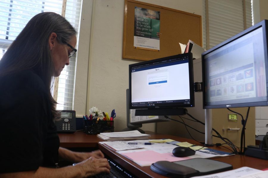 Signing into her school district portal, ESE Coordinator Julie Craver finishes her tasks before an upcoming meeting. 
“I do meetings [with] kids that have been identified as having some kind of a learning disability, or maybe have an emotional disability or a physical disability,” Mrs. Craver said. “[Then], we go through a process of [deeming] them eligible, and we develop whats called an Individual Education Plan (IEP) for those kids.” 
