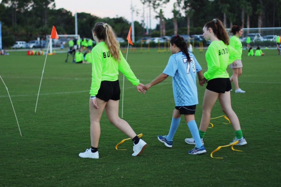 TOPSoccer volunteers help their buddies participate in a drill before the end of the session scrimmage. “They all get so happy and excited when kicking the ball,” communications freshman Cameron Wilson said. “It’s the little things that make their day and mine.”