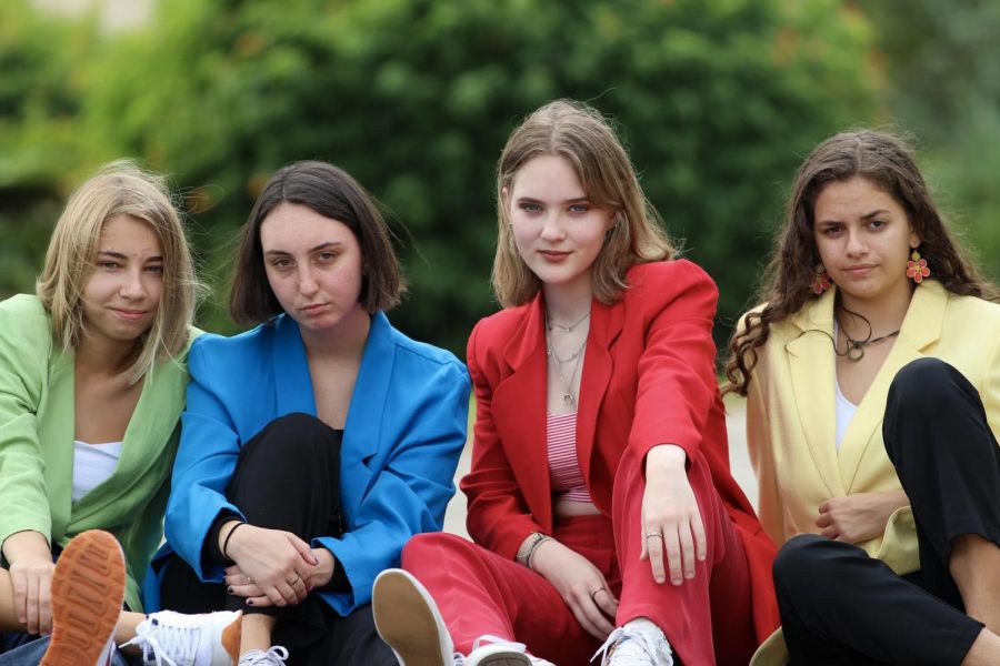 Communications sophomore Kaja Andric, communications juniors Zoë Goldenfarb and Isabella Weiss, and strings junior Abbey Magnolia pose, wearing matching blazers. 
