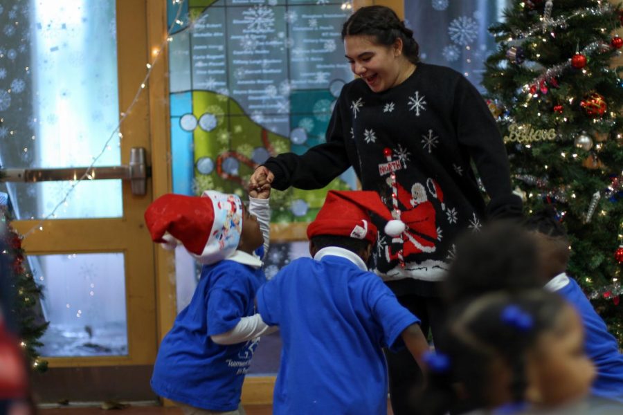 Spinning around with kids on the dance floor, dance senior Sasha Sagel sways along to the student jazz ensemble. Jefferson Jubilee brought the chance for students to give back to the community and underprivileged elementary schools by giving them gifts and creating a winter wonderland holiday celebration.