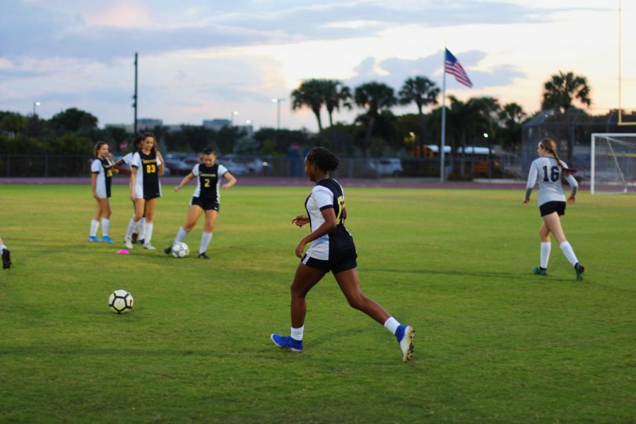 Band freshman Ava DeGaetano receives the ball from a teammate in preparation for their game. They focused on pass accuracy during the warmup, a strength the soccer team has been working on. “We connect very well with each other,” DeGaetano said, “on and off the soccer field.”