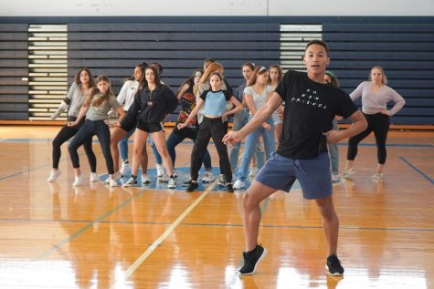 Mason Evans, dance sophomore and choreographer for the sophomore pep rally dance, executes a new move while rehearsing with his dancers.  