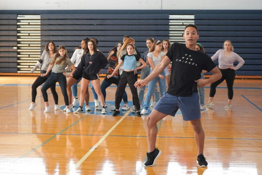 Mason+Evans%2C+dance+sophomore+and+choreographer+for+the+sophomore+pep+rally+dance%2C+executes+a+new+move+while+rehearsing+with+his+dancers.++