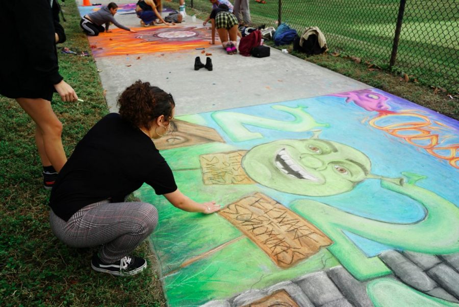 Visual sophomore Alyssa Gonzalez finishes the “Shrek” 2022 portrait for the Generation Day sidewalk chalk competition. “Last night, we worked on it for three hours and this morning we added finishing touches,” Gonzalez said.   