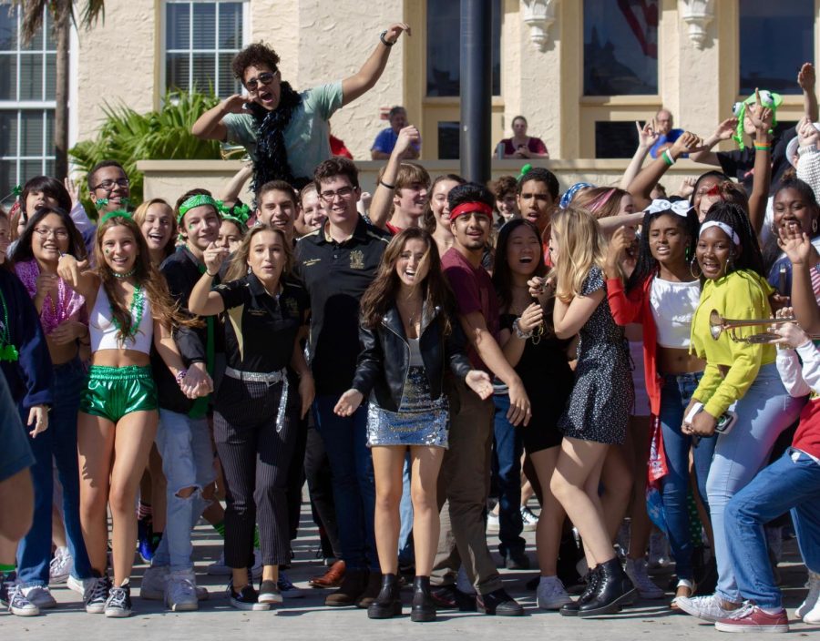 SGA+co-presidents+Kristina+Ronan+and+Sebastian+Fernandez+cheer+alongside+students+from+other+classes+as+the+last+shot+of+the+Lip+Dub+is+filmed+at+the+front+of+the+school.+Students+get+on+top+of+each+other%E2%80%99s+shoulders+and+wave+around+props+from+their+own+costumes+to+be+seen+in+the+drone+shot.