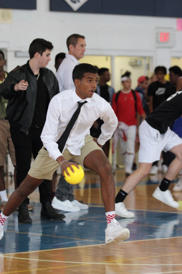 Visual sophomore William Dhana bolts forward to throw a ball at the seniors. The sophomores tied with the freshmen for last place in the dodgeball game.

