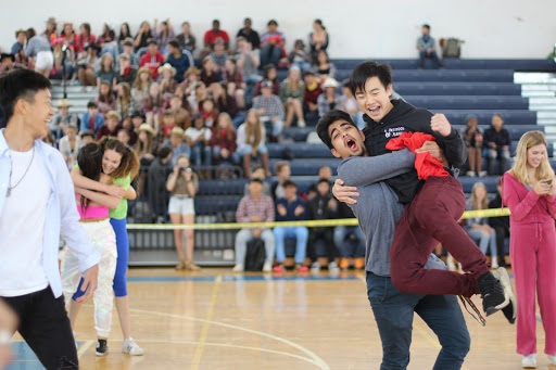 Raising piano junior Ethan Cheung into the air, vocal junior Arman Koshbin celebrates the juniors’ victory in “Knight, Mount, Carry.” Cheung had the opportunity to compete alongside piano junior David Liu. “Before the game, David and I created a strategy to win,” Cheung said. “We’re both really good friends and have established chemistry.”