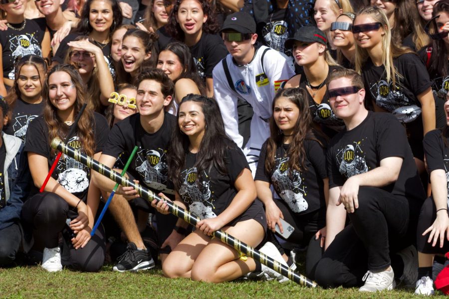 Senior Class Council president Nikolas Zimmerman holds the spirit totem pole with his co-president Mara Vaknin as the entire class celebrates their victory for spirit week. I was honestly just happy because I love seeing the class so happy, Zimmerman said. The class just worked so much better together this year and I love that we were awarded for the hard work and time that we put into the job.