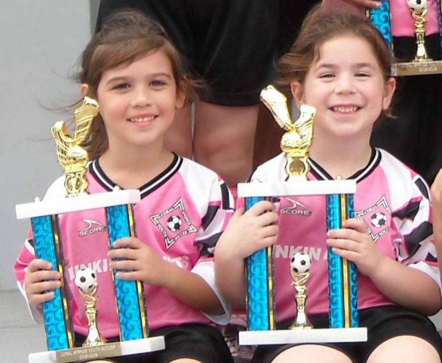 Sitting with her late friend Jaime Guttenberg, digital media sophomore Becca Fineberg (right) smiles with her soccer trophy in hand. Jaime Guttenberg was one of the 17 lives lost in the Marjory Stoneman Douglas shooting two years ago. 