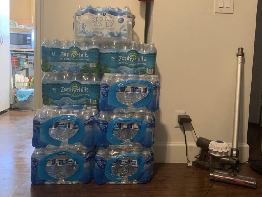 A stack of boxed water bottles lay on the side of communication sophomore Alyssa Jean-Louis’ kitchen. 