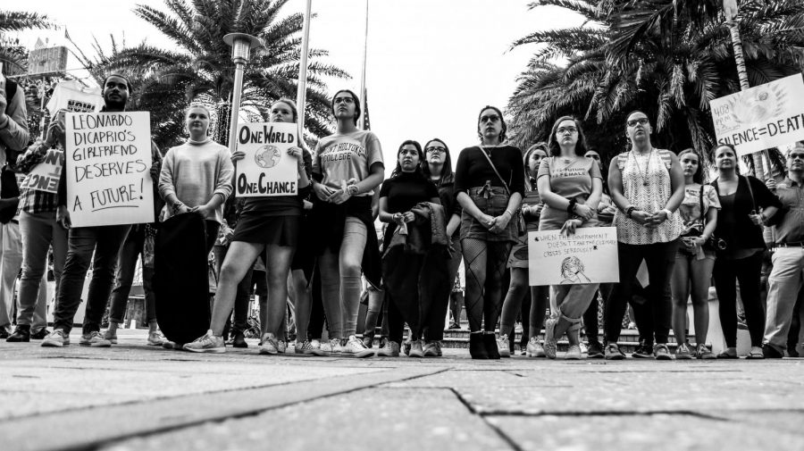 Dreyfoos students and community members stand, holding homemade signs, at a Palm Beach 4 Planet Climate Strike. Photo by Allison Robbert.