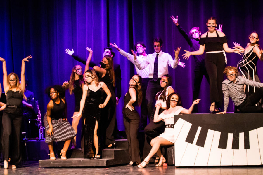 The cast of The World Goes ‘Round strike their final poses in the last number as the audience applauds and the curtain descends.