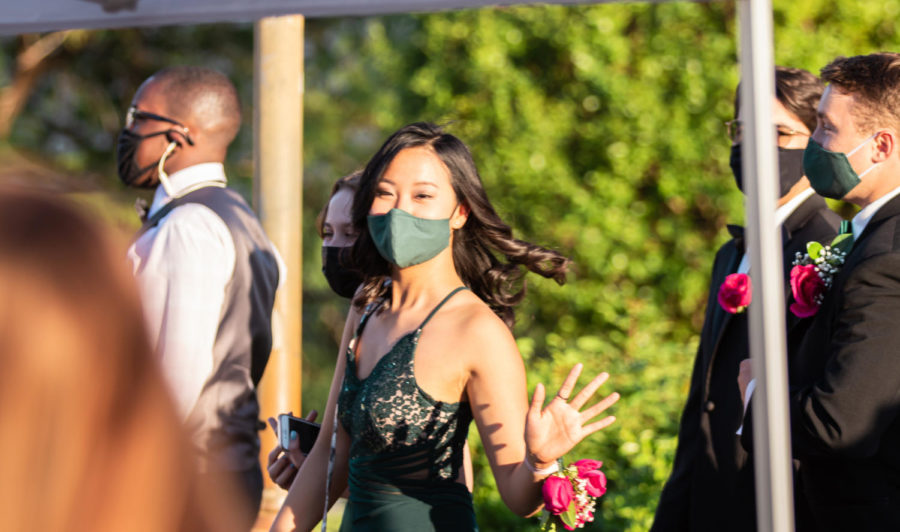 Band senior Autumn Wong waves as she walks into the Senior Banquet. 