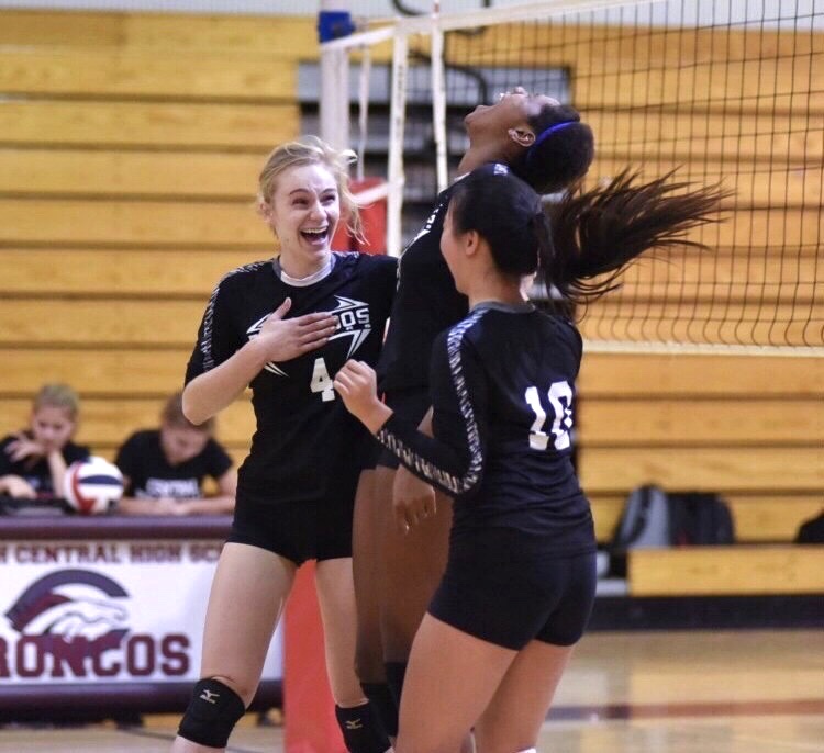 After a point by outside hitter and visual senior Julia Gonello, band senior Autumn Wong  and graduate Czhen Beneby celebrate together in a game against Palm Beach Central during the 2020 volleyball season. Photo courtesy of Autumn Wong.