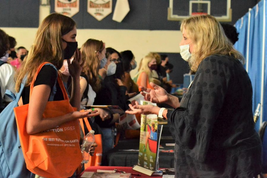 Searching for her future school, digital sophomore Alice Mackenzie talks with a college representative while other students gather alongside her at different booths. At the annual College Fair, students had the opportunity to interact with representatives from over 80 schools nationwide. They had time to ask questions and exchange contact information to learn more about colleges they are interested in. 
