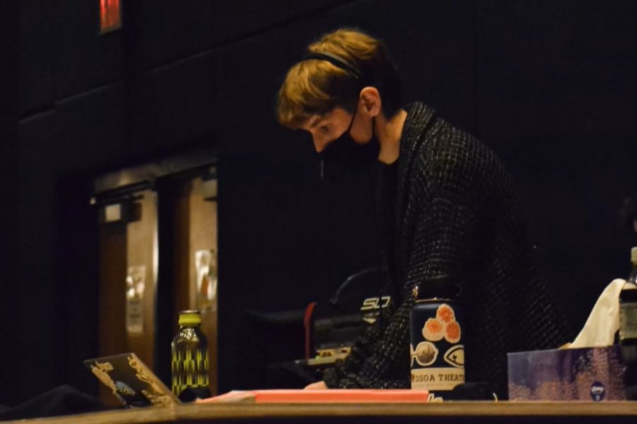 Preparing for the dress rehearsal, theatre senior Trey Mazza works behind the stage of the production “Pride and Prejudice.” During these rehearsals, Mazza writes down details regarding blocking to help each scene run smoothly and ensure the actors are aware of what to do. “I use all types of spreadsheets to keep organized from costume changes, sound cues, props, blocking, and set changes.” Mazza said. “This organization tactic is the structure behind the production.” 
