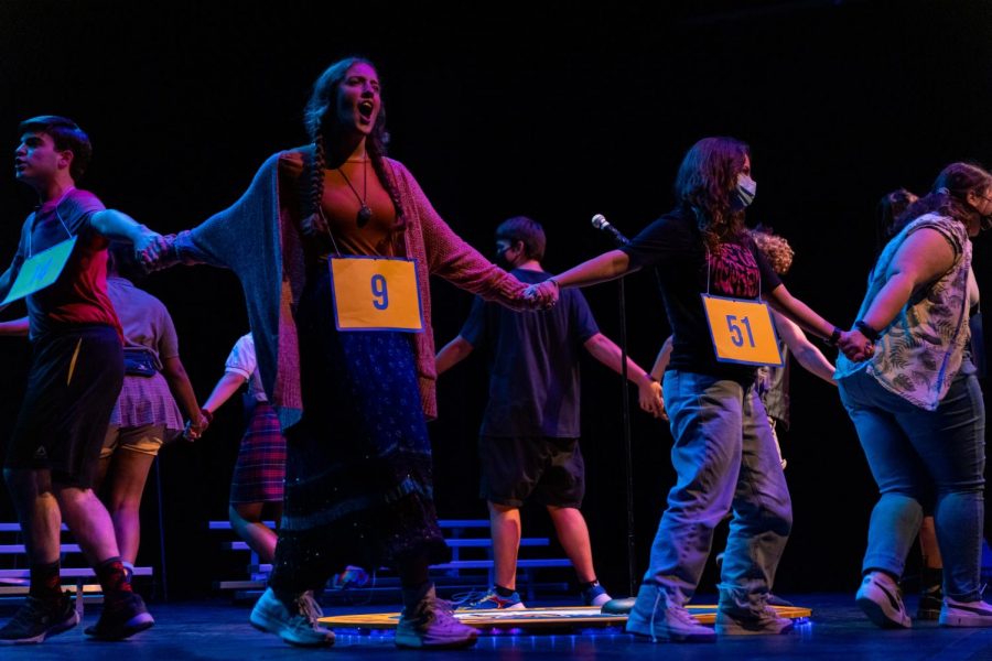 Circling the main platform, the cast of “The Bee” performs “Pandemonium,” accompanied by audience volunteers, for the crowd of theatre students during the Nov. 10 preview. This was their first show with an audience and served as a chance to improve any last components before the official show opening. 